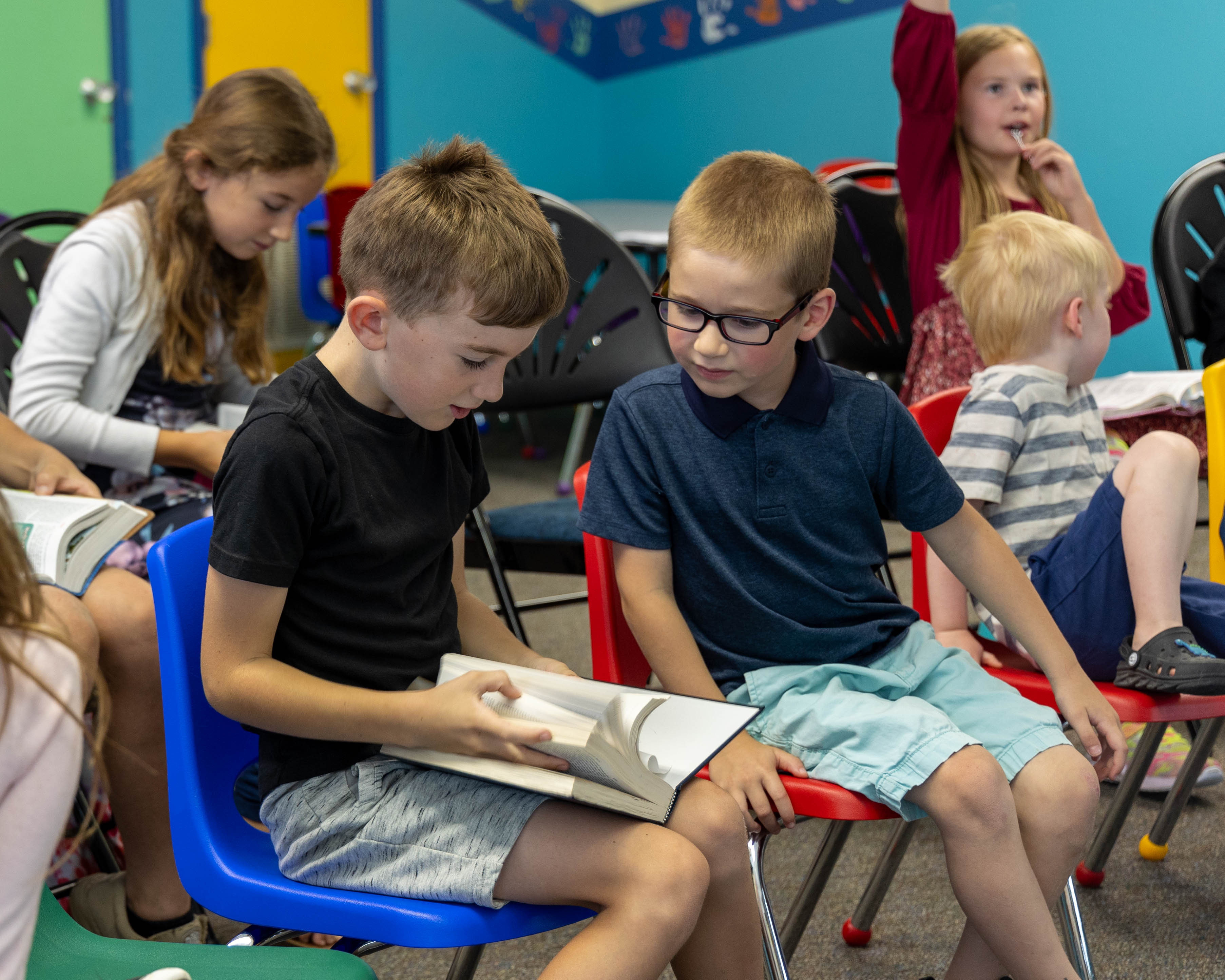 Children looking at a Bible together
